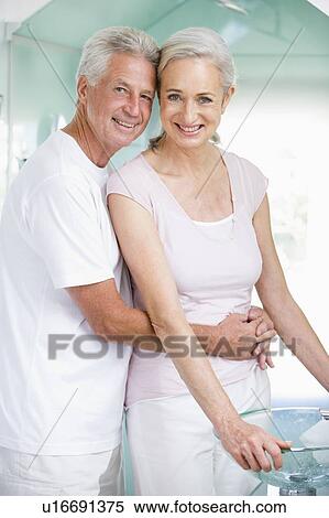 Stock Photography - Couple embracing at a spa and smiling. Fotosearch