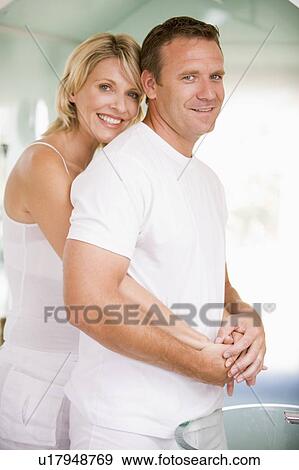 Stock Photo - Couple in bathroom embracing and smiling. Fotosearch