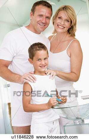 Couple in bathroom with young boy brushing teeth View Large Photo Image Stock Photo - Couple in bathroom with young boy brushing teeth. Fotosearch