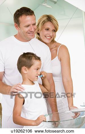 Couple in bathroom with young boy brushing teeth View Large Photo Image Stock Photograph - Couple in bathroom with young boy brushing teeth. Fotosearch