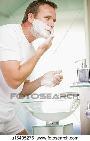 Man in bathroom shaving View Large Photo Image Stock Photograph - Man in bathroom shaving. Fotosearch