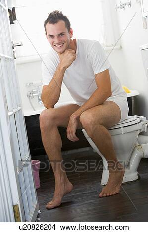 Man sitting in a bathroom View Large Photo Image Picture - Man sitting in a bathroom. Fotosearch