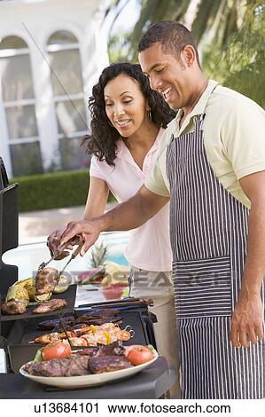 Couple Cooking On A Barbeque View Large Photo Image Stock Image - Couple Cooking On A Barbeque. Fotosearch