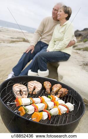 Couple Cooking On A Barbeque View Large Photo Image Stock Photograph - Couple Cooking On A Barbeque. Fotosearch