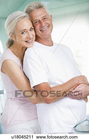 Couple embracing at a spa and smiling View Large Photo Image Stock Image - Couple embracing at a spa and smiling. Fotosearch