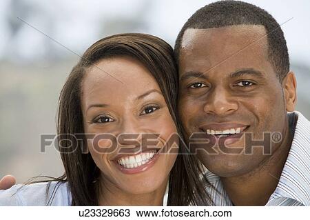 Stock Image - Couple outdoors smiling. Fotosearch