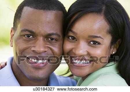 Stock Photo - Couple outdoors smiling. Fotosearch