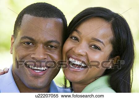 Stock Photography - Couple outdoors smiling. Fotosearch