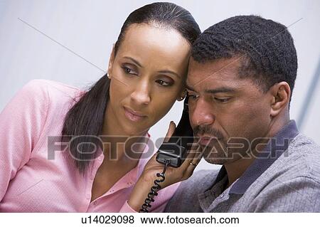 Couple receiving a bad news phone call from clinic View Large Photo Image Stock Photo - Couple receiving a bad news phone call from clinic. Fotosearch