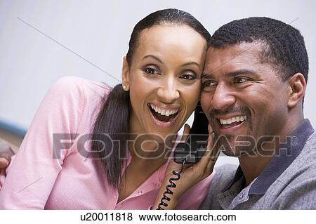 Couple receiving a good news phone call from clinic View Large Photo Image Stock Photo - Couple receiving a good news phone call from clinic. Fotosearch