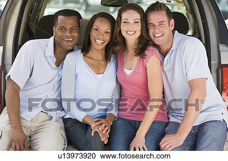 Two couples sitting in back of van smiling View Large Photo Image Stock Image - Two couples sitting in back of van smiling. Fotosearch