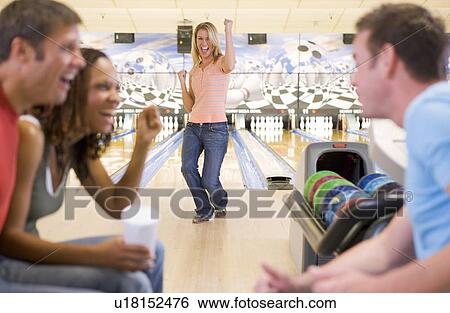 Woman bowling with friends View Large Photo Image Stock Photograph - Woman bowling with friends. Fotosearch