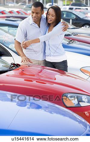 Young couple shopping for a new car View Large Photo Image Picture - Young couple shopping for a new car. Fotosearch