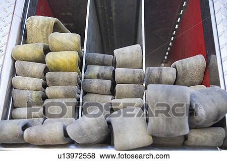Fire hoses neatly stacked in fire engine View Large Photo Image Stock Photo - Fire hoses neatly stacked in fire engine. Fotosearch