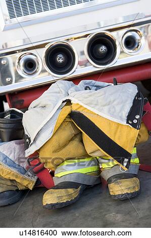 Firefighting uniforms in front of a fire engine View Large Photo Image Stock Image - Firefighting uniforms in front of a fire engine. Fotosearch