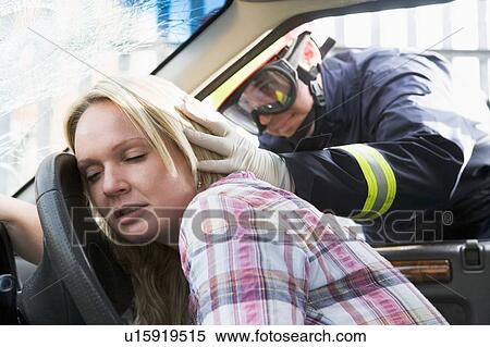 Fireman helping a woman after she got in an accident View Large Photo Image Stock Photography - Fireman helping a woman after she got in an accident. Fotosearch