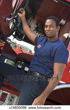 Fireman leaning in door of fire engine View Large Photo Image Stock Photo - Fireman leaning in door of fire engine. Fotosearch