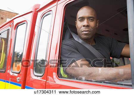 Fireman sitting in fire engine looking out window View Large Photo Image Stock Image - Fireman sitting in fire engine looking out window. Fotosearch