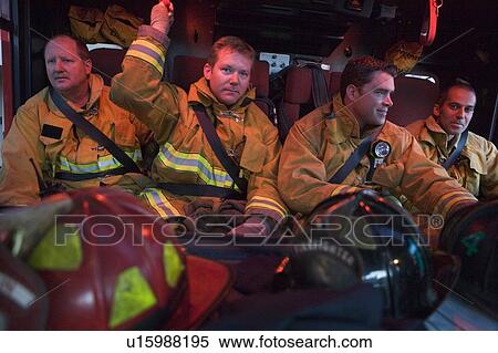 Four firemen in fire engine with gear View Large Photo Image Stock Photography - Four firemen in fire engine with gear. Fotosearch