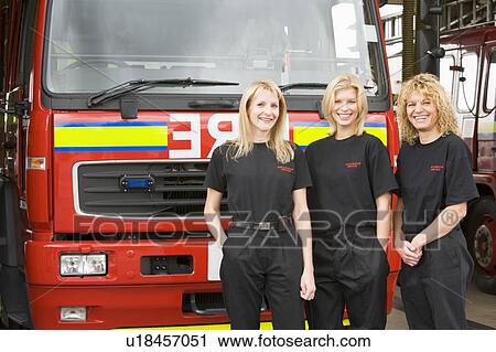 Three firefighters standing in front of fire engine View Large Photo Image Stock Image - Three firefighters standing in front of fire engine. Fotosearch