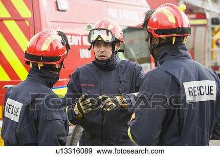 Three rescue workers talking by rescue vehicle View Large Photo Image Stock Photo - Three rescue workers talking by rescue vehicle. Fotosearch