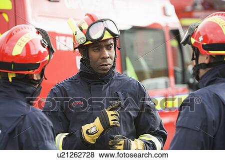 Three rescue workers talking by rescue vehicle (selective focus) View Large Photo Image Stock Photo - Three rescue workers talking by rescue vehicle (selective focus). Fotosearch