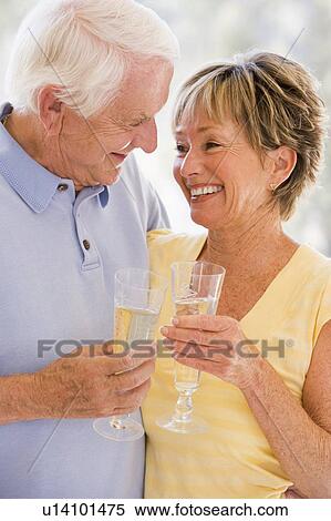 Couple drinking champagne and smiling View Large Photo Image Stock Photography - Couple drinking champagne and smiling. Fotosearch
