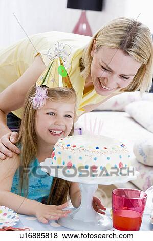 Mother and daughter with birthday cake smiling View Large Photo Image Stock Photo - Mother and daughter with birthday cake smiling. Fotosearch