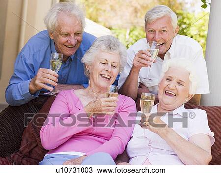 Two couples on patio drinking champagne and smiling View Large Photo Image Stock Image - Two couples on patio drinking champagne and smiling. Fotosearch
