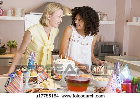 Two women at party getting sandwiches smiling View Large Photo Image Picture - Two women at party getting sandwiches smiling. Fotosearch
