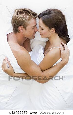 Couple lying in bed sleeping View Large Photo Image Stock Photography - Couple lying in bed sleeping. Fotosearch
