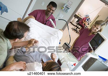 Stock Image - Doctor retrieving eggs from ovary using vaginal ultrasound. Fotosearch