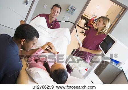 Stock Photo - Doctor retrieving eggs from ovary using vaginal ultrasound. Fotosearch