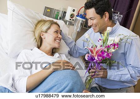 Man Giving His Pregnant Wife Flowers View Large Photo Image Stock Photo - Man Giving His Pregnant Wife Flowers. Fotosearch