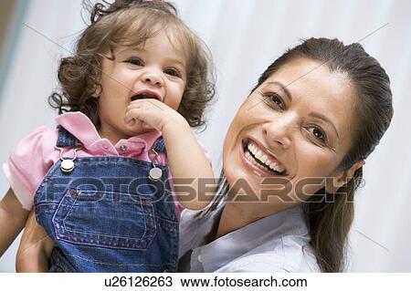 Mother holding IVF child smiling View Large Photo Image Stock Image - Mother holding IVF child smiling. Fotosearch