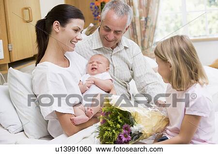 New mother with baby and family in hospital smiling View Large Photo Image Stock Image - New mother with baby and family in hospital smiling. Fotosearch