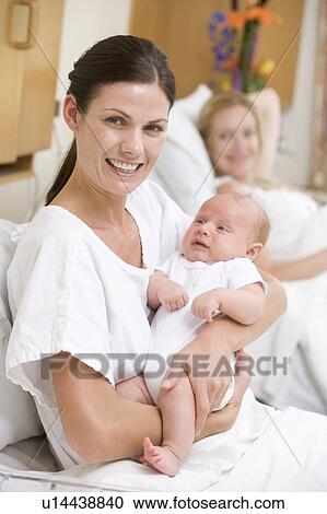 New mother with baby in hospital smiling View Large Photo Image Stock Image - New mother with baby in hospital smiling. Fotosearch