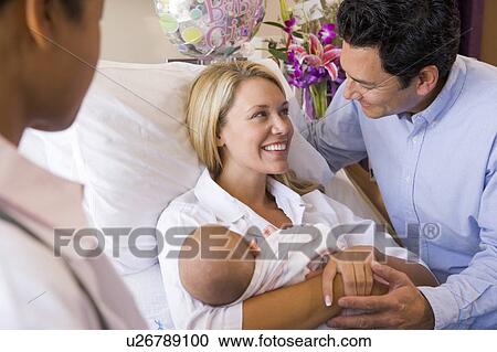New parents with baby talking to doctor and smiling View Large Photo Image Stock Image - New parents with baby talking to doctor and smiling. Fotosearch