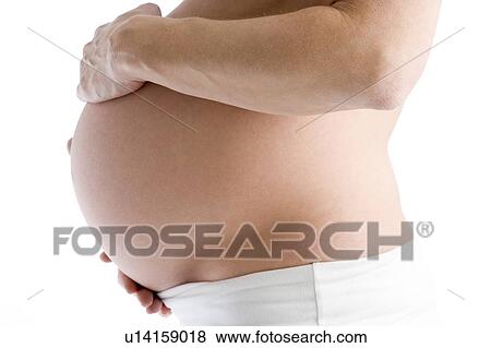Pregnant woman holding exposed belly View Large Photo Image Stock Photo - Pregnant woman holding exposed belly. Fotosearch