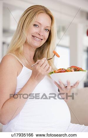 Pregnant woman with bowl of salad smiling View Large Photo Image Stock Photograph - Pregnant woman with bowl of salad smiling. Fotosearch
