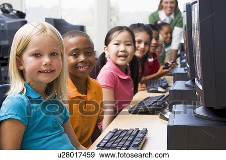 Children at computer terminals with teacher in background (depth of field/high key) View Large Photo Image Stock Photo - Children at computer terminals with teacher in background (depth of field/high key). Fotosearch