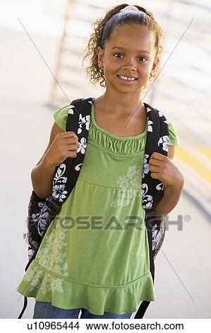 Student standing outdoors smiling (high key) View Large Photo Image Picture - Student standing outdoors smiling (high key). Fotosearch