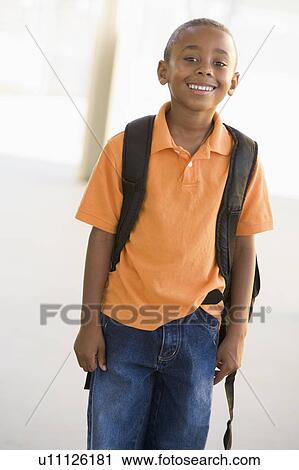 Student standing outdoors smiling (high key) View Large Photo Image Stock Image - Student standing outdoors smiling (high key). Fotosearch