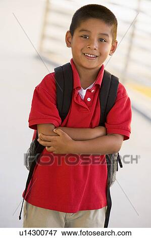 Student standing outdoors smiling (high key) View Large Photo Image Stock Photo - Student standing outdoors smiling (high key). Fotosearch