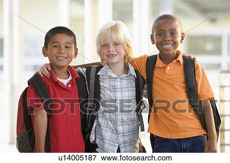 Three students outside school standing together smiling (selective focus) View Large Photo Image Stock Photo - Three students outside school standing together smiling (selective focus). Fotosearch
