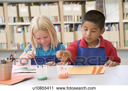 Two students in art class painting View Large Photo Image Stock Image - Two students in art class painting. Fotosearch