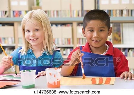 Stock Photo - Two students in art class painting. Fotosearch
