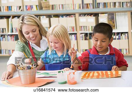 Two students in art class with teacher View Large Photo Image Picture - Two students in art class with teacher. Fotosearch