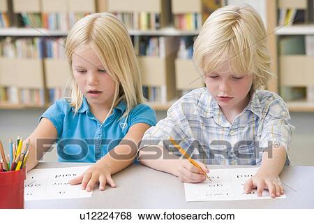 Two students in class learning letters View Large Photo Image Stock Photo - Two students in class learning letters. Fotosearch