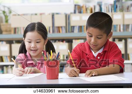 Two students in class writing View Large Photo Image Stock Image - Two students in class writing. Fotosearch